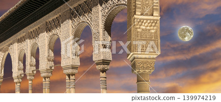 Arches in Islamic (Moorish) style (against the sunset with the super moon) in Alhambra, Granada, Spain 139974219