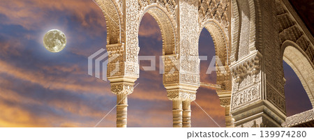 Arches in Islamic (Moorish) style (against the sunset with the super moon) in Alhambra, Granada, Spain 139974280