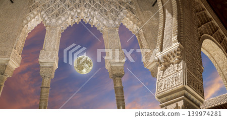 Arches in Islamic (Moorish) style (against the sunset with the super moon) in Alhambra, Granada, Spain 139974281