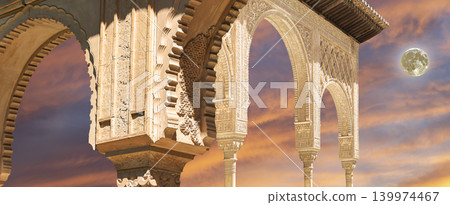 Arches in Islamic (Moorish) style (against the sunset with the super moon) in Alhambra, Granada, Spain Arches in Islamic (Moorish) style (against the sunset with the super moon) in Alhambra, Granada, Spain 139974467