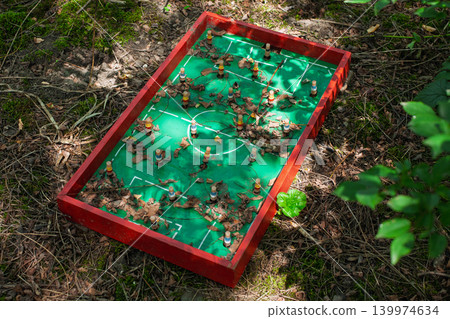 Old abandoned foosball game in autumn forest Old abandoned foosball game in autumn forest 139974634
