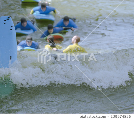 Surfers Riding Body boards in Waves Surfers Riding Body boards in Waves 139974836