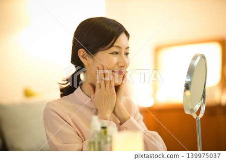Middle-aged women doing their nighttime skincare routine Middle-aged women doing their nighttime skincare routine 139975037
