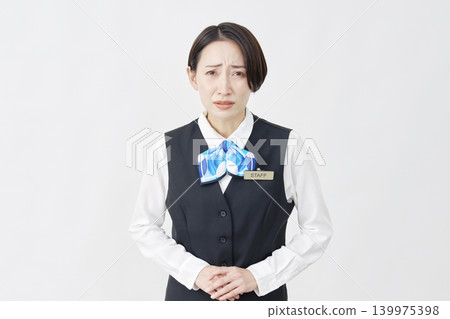 Female staff member, receptionist/bank employee, bowing/apologizing, white background Female staff member, receptionist/bank employee, bowing/apologizing, white background 139975398