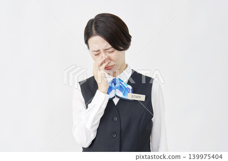 Crying female staff member (receptionist/bank employee) against a white background Crying female staff member (receptionist/bank employee) against a white background 139975404