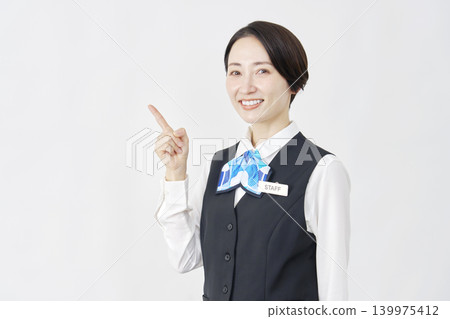 女性工作人員指向左側；接待員/銀行職員；白色背景。 139975412