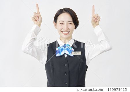 Female staff member pointing upwards; receptionist/bank employee; white background. 139975415