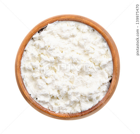 Quark, fresh farmers cheese in a wooden bowl. Also called quarg or curd cheese, a dairy product made from milk that is soured by adding lactic acid bacteria cultures and strained after curdling. Photo Quark, fresh farmers cheese in a wooden bowl. Also called quarg or curd cheese, a dairy product made from milk that is soured by adding lactic acid bacteria cultures and strained after curdling. Photo 139975470