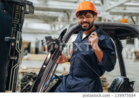 Forklift, machinery to help. Portrait of a male carpenter posing in a woodworking workshop Forklift, machinery to help. Portrait of a male carpenter posing in a woodworking workshop 139975684