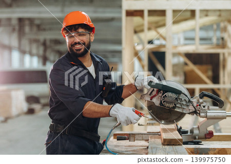 Portrait of a male carpenter posing in a woodworking workshop 139975750