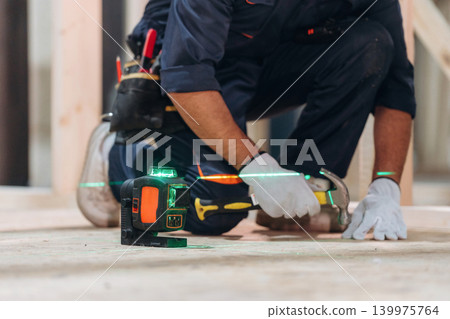 Close-up of a carpenter working with wood using professional tools in a workshop Close-up of a carpenter working with wood using professional tools in a workshop 139975764