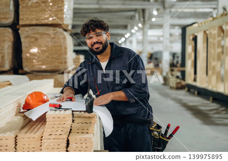 In a professional workshop. Male carpenter working with wooden materials 139975895