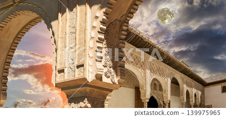 Arches in Islamic (Moorish) style (against the sunset with the super moon) in Alhambra, Granada, Spain Arches in Islamic (Moorish) style (against the sunset with the super moon) in Alhambra, Granada, Spain 139975965