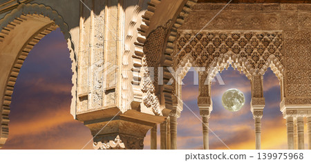 Arches in Islamic (Moorish) style (against the sunset with the super moon) in Alhambra, Granada, Spain 139975968