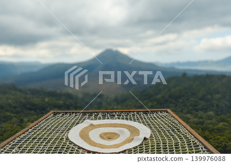 Straw target design with mountains in background and cloudy sky Straw target design with mountains in background and cloudy sky 139976088