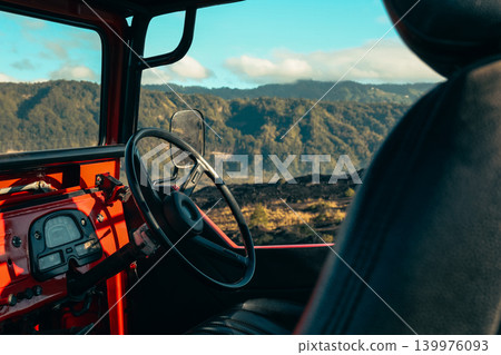 View inside a vintage vehicle with mountains in the background View inside a vintage vehicle with mountains in the background 139976093