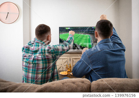 Kiev, Ukraine, March 25, 2026: Watching football with Corona Beer Kiev, Ukraine, March 25, 2026: Watching football with Corona Beer 139976156