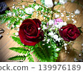 A gorgeous bouquet of red roses and baby's breath. 139976189