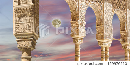 Arches in Islamic (Moorish) style (against the sunset with the super moon) in Alhambra, Granada, Spain Arches in Islamic (Moorish) style (against the sunset with the super moon) in Alhambra, Granada, Spain 139976310
