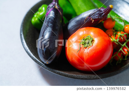 Assortment of fresh, dewy summer vegetables: tomatoes, eggplant, cucumbers, zucchini, and peppers Assortment of fresh, dewy summer vegetables: tomatoes, eggplant, cucumbers, zucchini, and peppers 139976582