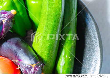 Assortment of fresh, dewy summer vegetables: tomatoes, eggplant, cucumbers, zucchini, and peppers Assortment of fresh, dewy summer vegetables: tomatoes, eggplant, cucumbers, zucchini, and peppers 139976585