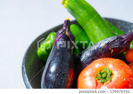 Assortment of fresh, dewy summer vegetables: tomatoes, eggplant, cucumbers, zucchini, and peppers Assortment of fresh, dewy summer vegetables: tomatoes, eggplant, cucumbers, zucchini, and peppers 139976592