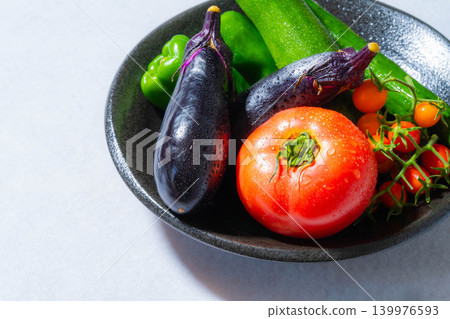 Assortment of fresh, dewy summer vegetables: tomatoes, eggplant, cucumbers, zucchini, and peppers Assortment of fresh, dewy summer vegetables: tomatoes, eggplant, cucumbers, zucchini, and peppers 139976593