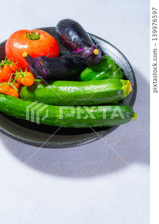 Assortment of fresh, dewy summer vegetables: tomatoes, eggplant, cucumbers, zucchini, and peppers Assortment of fresh, dewy summer vegetables: tomatoes, eggplant, cucumbers, zucchini, and peppers 139976597