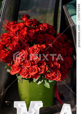 Large Bouquet of Deep Red Roses in a Green Vase for Romantic Celebration and Valentine's Day Large Bouquet of Deep Red Roses in a Green Vase for Romantic Celebration and Valentine's Day 139976946