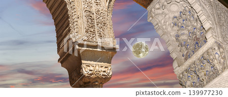 Arches in Islamic (Moorish) style (against the sunset with the super moon) in Alhambra, Granada, Spain 139977230
