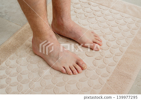 getting out of the shower after bathing, close-up of a man's legs. High quality 4k footage getting out of the shower after bathing, close-up of a man's legs. High quality 4k footage 139977295