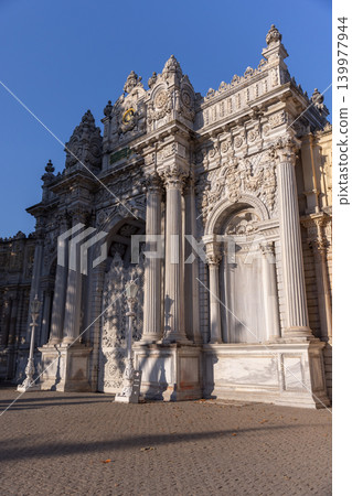 Ornate marble gate showcasing intricate Ottoman baroque carvings. Dolmabahce Palace Ornate marble gate showcasing intricate Ottoman baroque carvings. Dolmabahce Palace 139977944