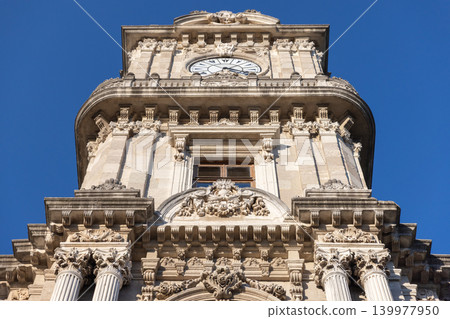 Ornate historic Dolmabahce Clock Tower built in 1895 featuring a detailed stone facade Ornate historic Dolmabahce Clock Tower built in 1895 featuring a detailed stone facade 139977950