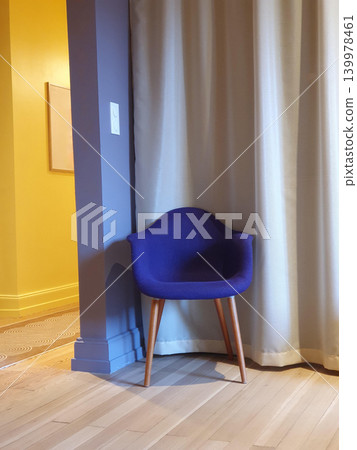 Phone photo of a modern minimalist interior with blue and yellow accents. Contemporary home or office space showing clean lines, open layout, and bold color contrast. Phone photo of a modern minimalist interior with blue and yellow accents. Contemporary home or office space showing clean lines, open layout, and bold color contrast. 139978461