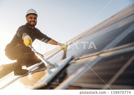 Male solar engineer examining photovoltaic panels at a power station Male solar engineer examining photovoltaic panels at a power station 139978774
