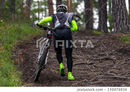 Athlete of mountain bike hard going uphill Athlete of mountain bike hard going uphill 139978938