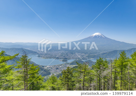 Lake Kawaguchi and Mount Fuji viewed from a mountain lush with new greenery. Lake Kawaguchi and Mount Fuji viewed from a mountain lush with new greenery. 139979114