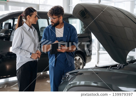 Technical inspection explained to customer indoors Technical inspection explained to customer indoors 139979397