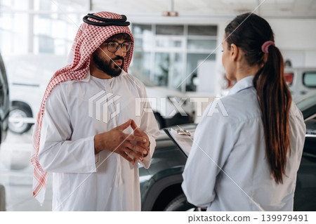 Premium class automobiles. Middle eastern client discussing car purchase in modern dealership 139979491