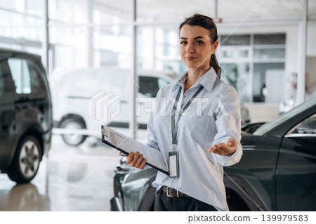How can I help you conception. Successful automotive consultant standing near car interior How can I help you conception. Successful automotive consultant standing near car interior 139979583