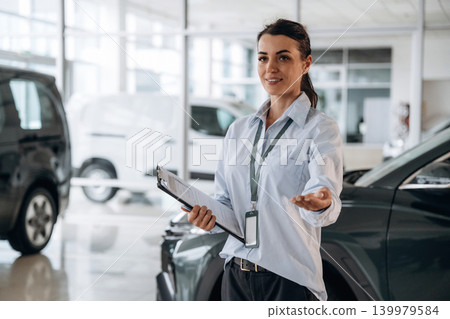 How can I help you conception. Successful automotive consultant standing near car interior 139979584