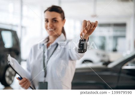Keys in hand, it can can be yours. Successful automotive consultant standing near car interior 139979590