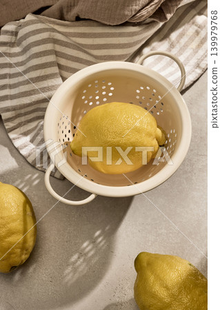 Fresh Lemons in a Vintage Colander with Sunny Shadows. Top View Fresh Lemons in a Vintage Colander with Sunny Shadows. Top View 139979768