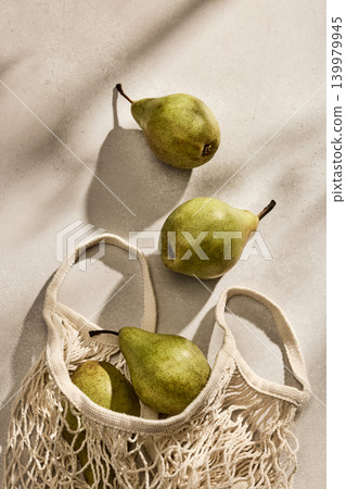 Fresh Italian pears in an Eco-Friendly Mesh Bag on a kitchen table. Top View 139979945
