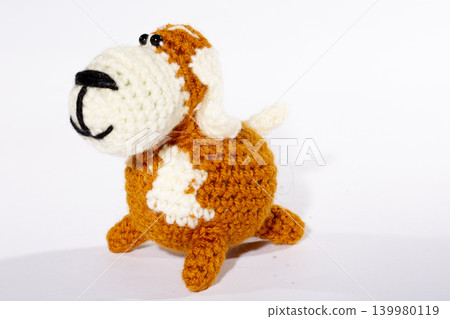 Knitted woolen dog on a white background Knitted woolen dog on a white background 139980119