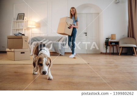 Young girl is moving into new home with her dog Young girl is moving into new home with her dog 139980262