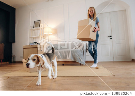 Young girl is moving into new home with her dog 139980264