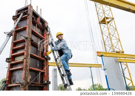 Construction worker working on a building formwork Construction worker working on a building formwork 139980426