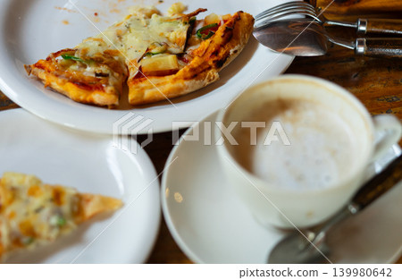 Viennese coffee and pizza on a wooden table Viennese coffee and pizza on a wooden table 139980642
