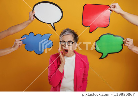 Woman in pink blazer expresses surprise while surrounded by colorful speech bubbles on a vibrant yellow background, showcasing communication and expression concepts Woman in pink blazer expresses surprise while surrounded by colorful speech bubbles on a vibrant yellow background, showcasing communication and expression concepts 139980867